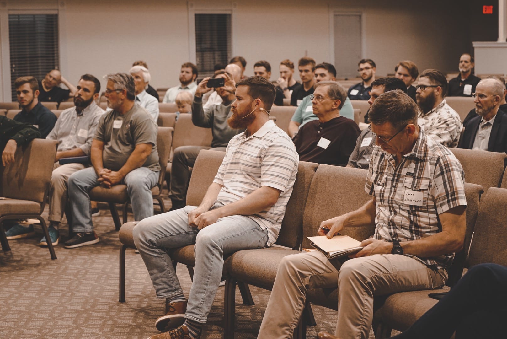 Men seated together listening at a Micah Mandate gathering